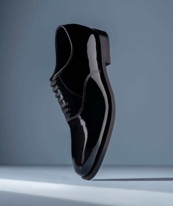 Men’s gray textured leather sneaker with tan rubber sole and brown leather lining